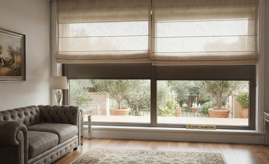 Elegant custom Roman blinds in a beige patterned fabric installed in a modern living room overlooking a private garden in Koramangala, Bangalore by Sanjar Furnishings